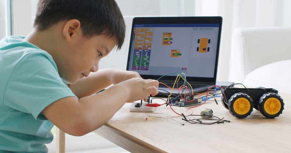 A child learning Arduino project on the computer
